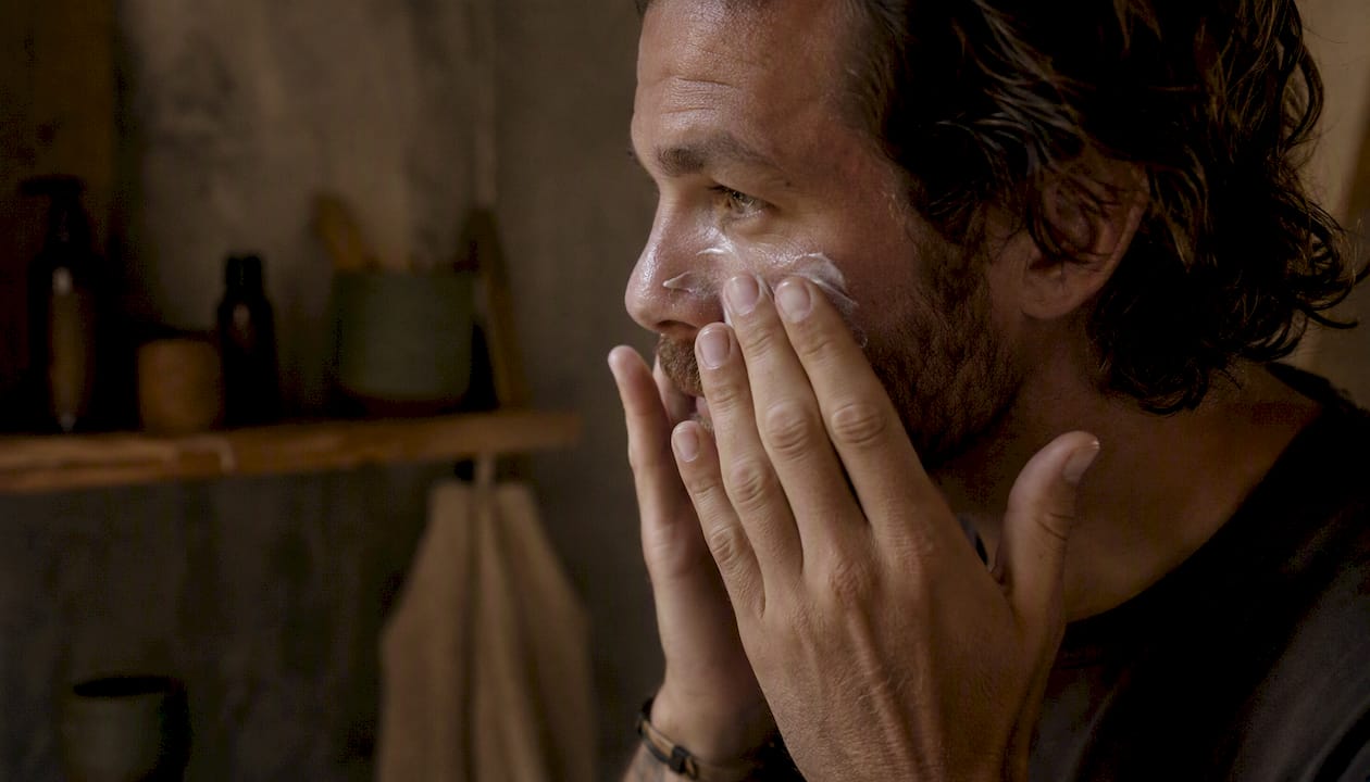 Man applying moisturizer on dry skin