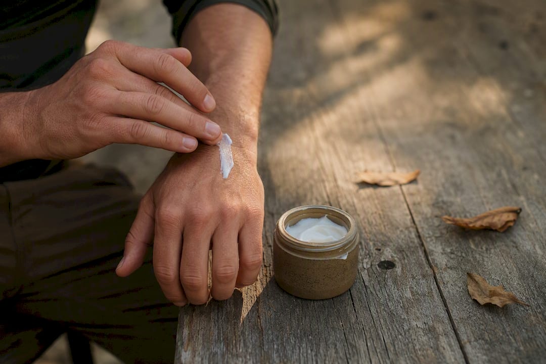 Hands scooping rich night moisturizer
