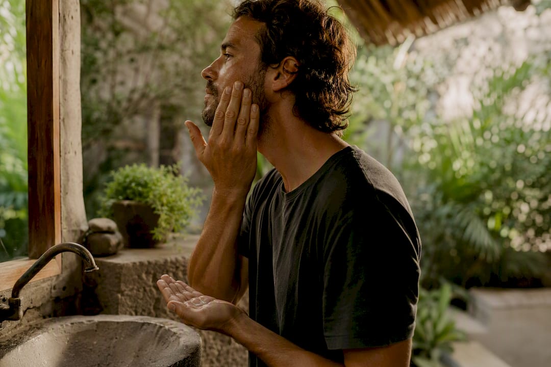 Man applying natural face balm